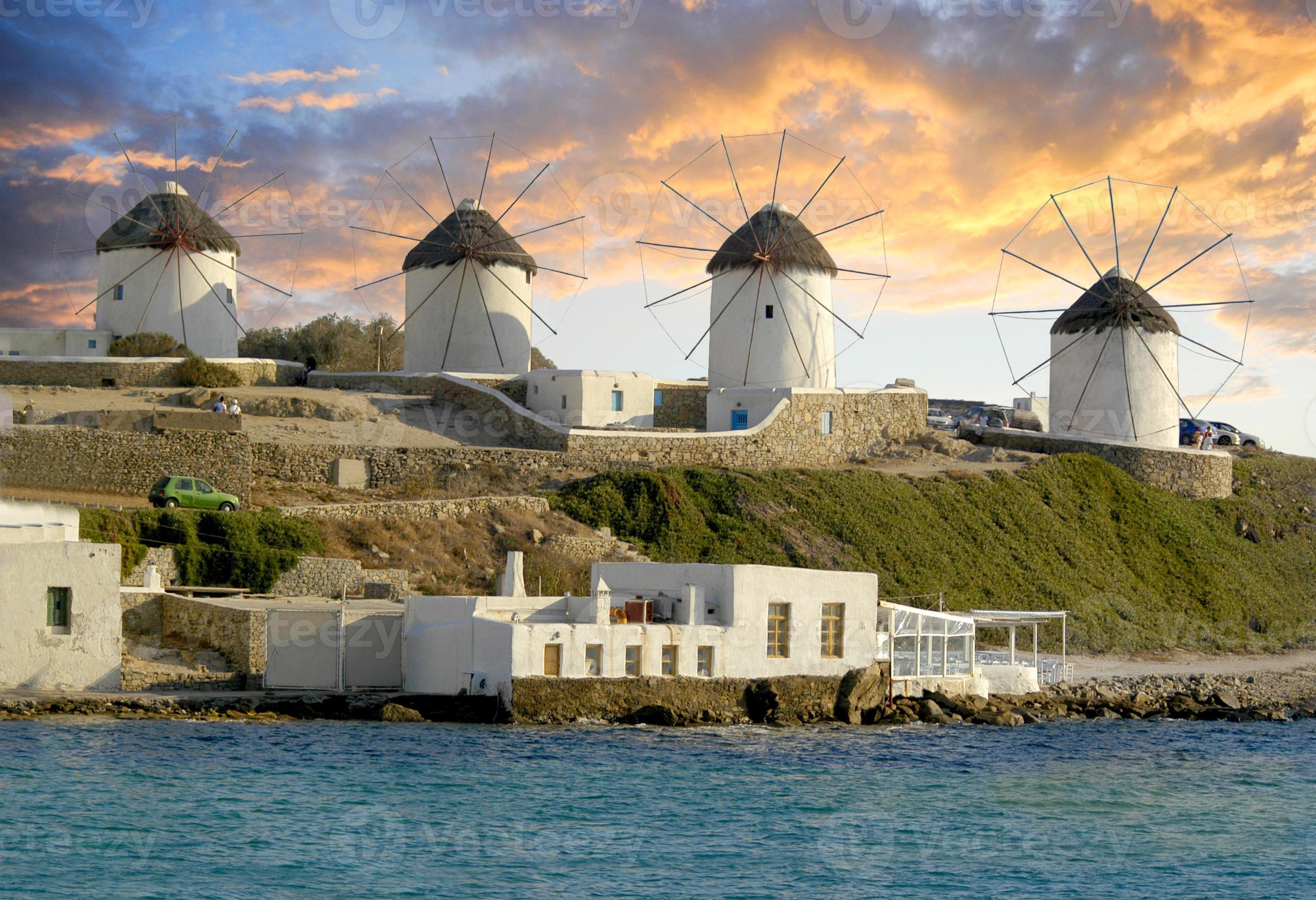 Mykonos windmills in front of a spectacular sunset lighting up the